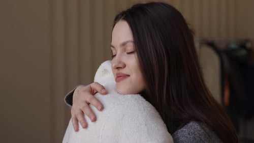 Woman Embracing a Man with Eyes Closed Indoors