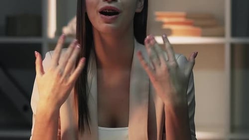 Business Woman Talking and Gesturing Indoors