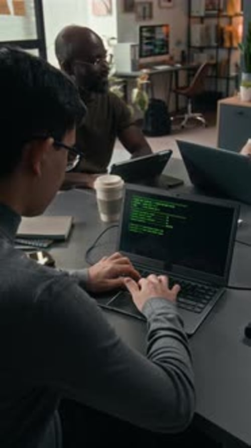 Colleagues Working on Computers in an Office Setting