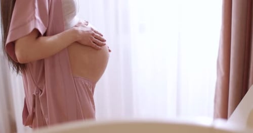 Pregnant Woman Caressing Belly Indoors, Expecting Child