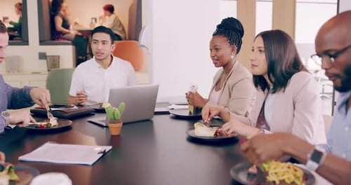 4k video footage of a group of young businesspeople having lunch during meeting in a modern office