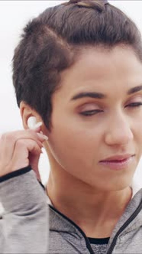 Fitness, earphones and athlete outdoor with smile, online radio or song subscription for start