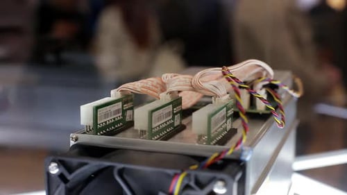 Cryptocurrency Mining Equipment ASIC Application Specific Integrated Circuit on Farm Stand at Expo