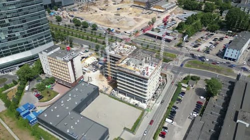 new residential district under construction. construction site with yellow tower cranes and machiner