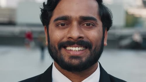 Close Up Indian Bearded Businessman with Stylish Hairstyle Smiling at Camera While Standing Outdoors