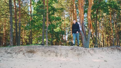 A Young Traveler is Exploring the Magnificent Forest Equipped with a Sturdy Backpack on His Back