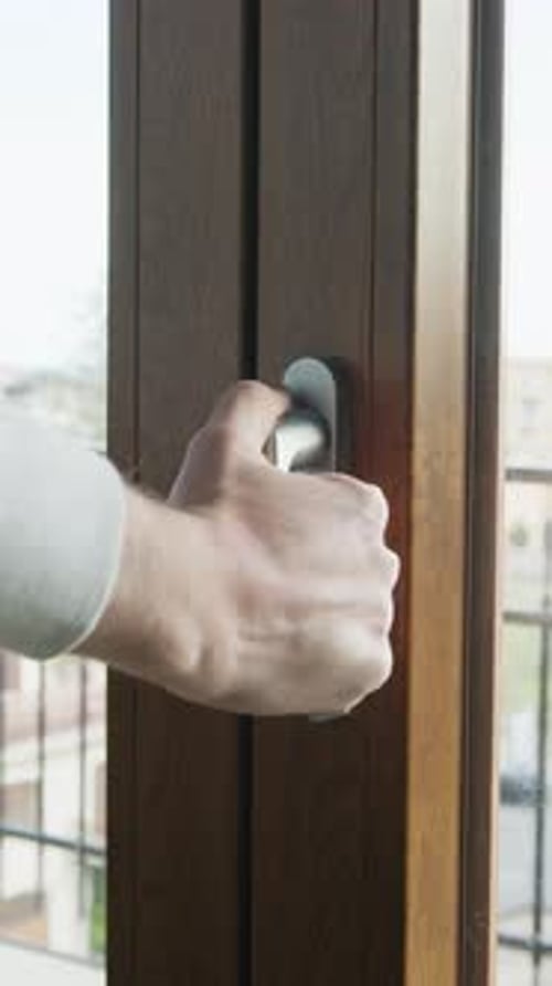 A Man's Hand Opens And Closes The Airtight Double Glass Window
