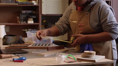 Black Female Carpenter Doing Woodwork in Workshop