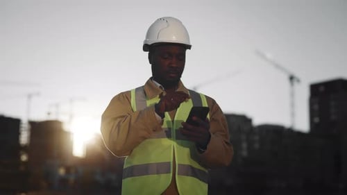 Foreman Using Mobile App in Smartphone for Counting Objects Medium Portrait Application for