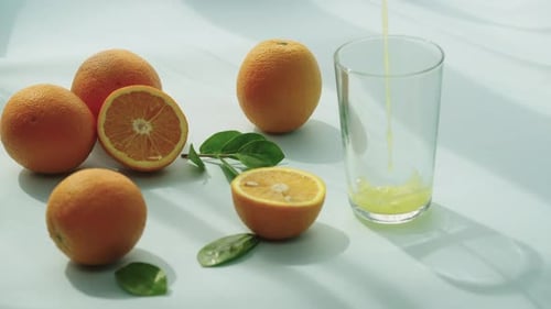 Pouring Fresh Orange Juice into a Glass