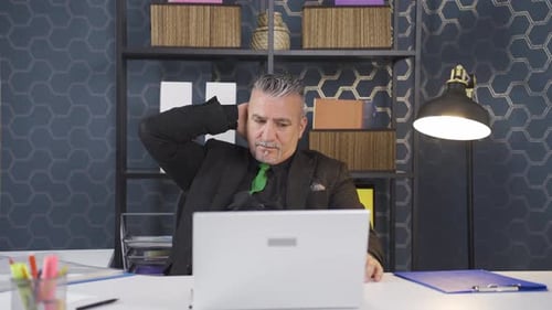 Man Working at Desk with Laptop