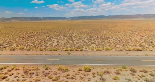 Desert highway car driving. Nevada desert road aerial shot.