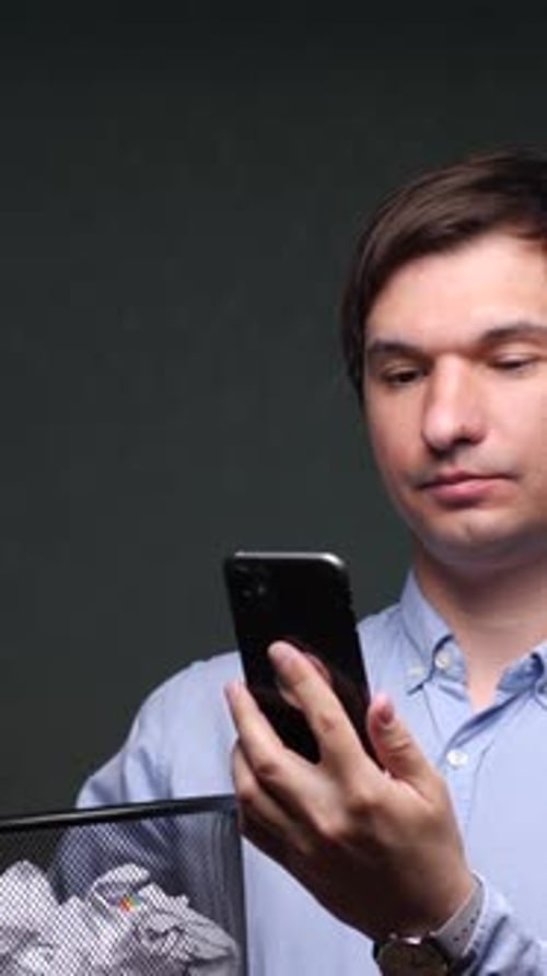 Vertical Video Closeup Man Throws Smartphone Into Trash Bin