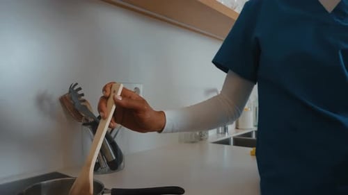 Attentive Woman Cooking for Senior Woman