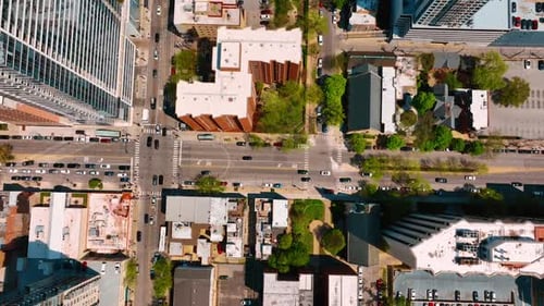 Streets and crossroads filled with cars moving by. Traffic in metropolis at daytime. Top view.