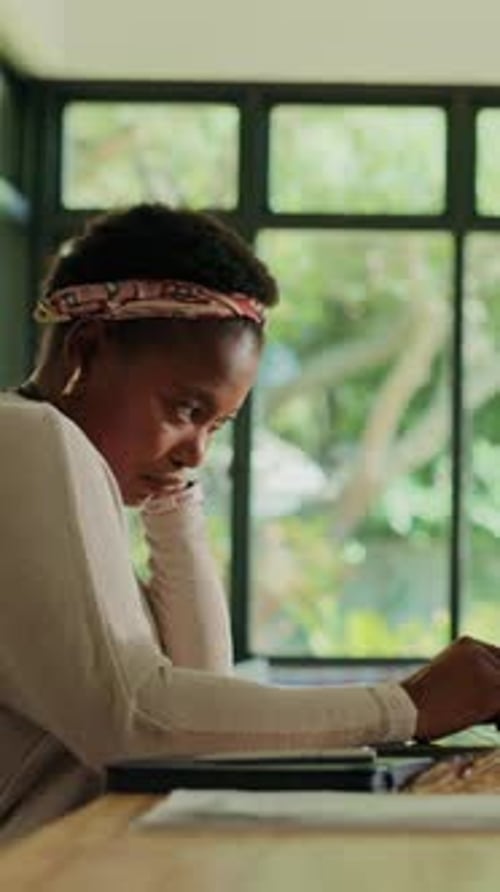 Woman Typing at Desk Inside by Sunny Window