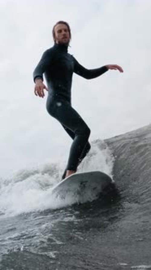 A Skilled Surfer Riding the Waves in a Dynamic Ocean Environment Showcasing Balance and Agility on a