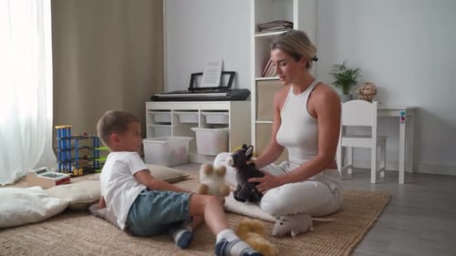 Child and Adult Playing with Stuffed Animals Indoors