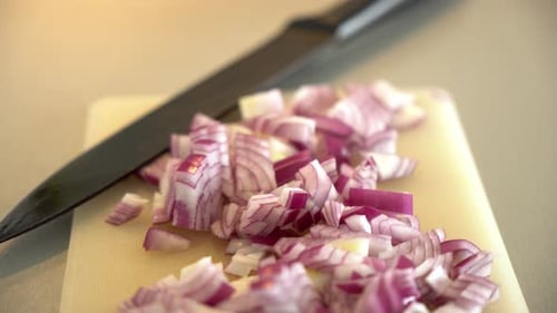 Diced Red Onions with Knife on Cutting Board