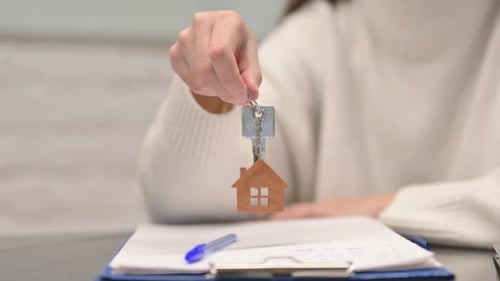 Close up of Woman Showing Home Keys