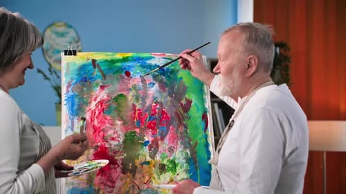 Senior Couple Collaborating on Abstract Painting at Home