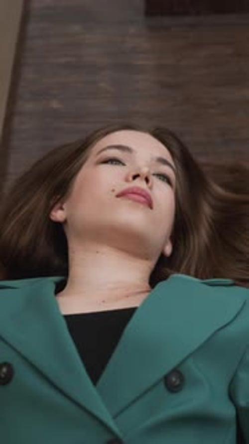 Woman Lying on Wooden Floor Looking Upward