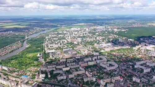 Cityscape under blue clouds. Beautiful view on the city surrounded by nature. Aerial view.