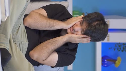 Vertical video of Desperate man with his hands on his head. Depressed.