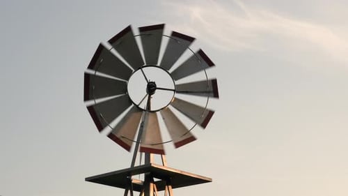 A small windmill turning in the light of the evening sun and breeze.