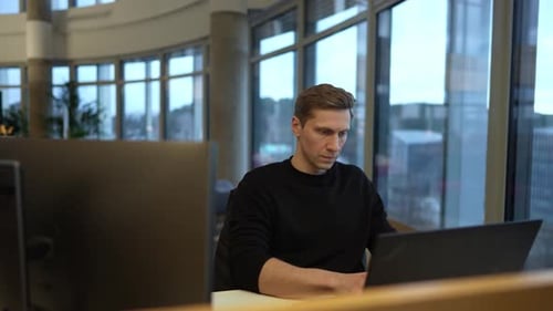 a programmer works at a computer, programs a neural network