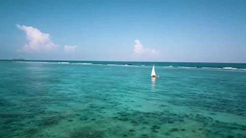 Amazing aerial drone flight panorama curve flight drone shot of a Sailboat with white sails.
Paradis