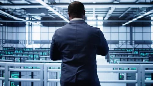 Technician Monitoring Server Room Supercomputers Doing Checkup