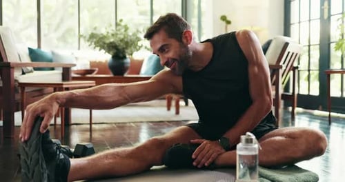 Adult Man Stretches On A Mat At Home
