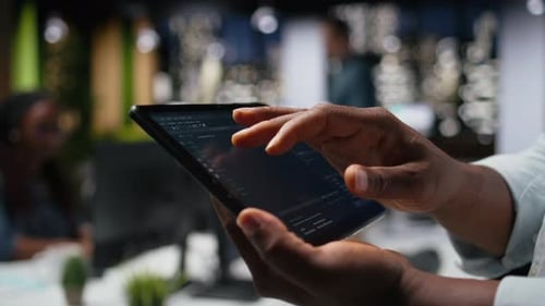 Close Up of Programmer Typing Code on Touchscreen Device