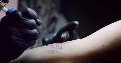 Milan/Italy-01.02.2019:Slow motion of professional master of the art of tattooing doing a tattoo t