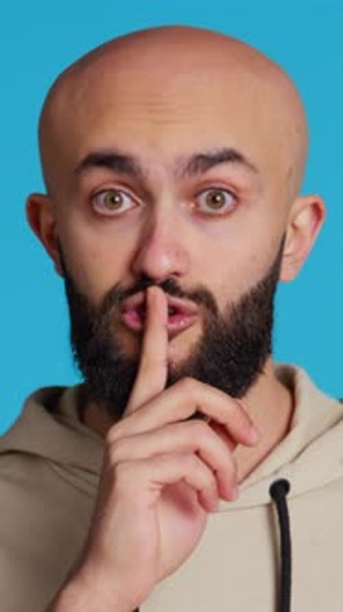 Vertical Video Middle Eastern Man Doing Hush Silence Symbol in Studio