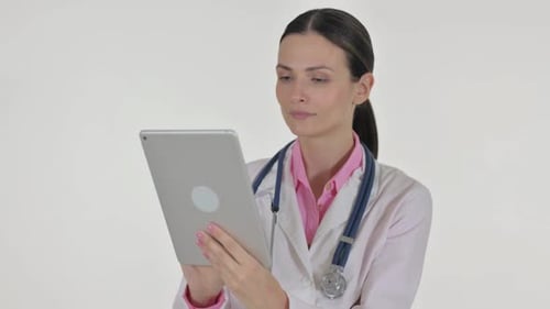 Woman Doctor Studies Tablet in Medical Environment