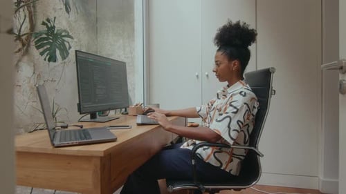 Female Programmer Coding on Computer at Work in the Office