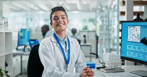 Smiling Scientist in Modern Bright Laboratory Workplace