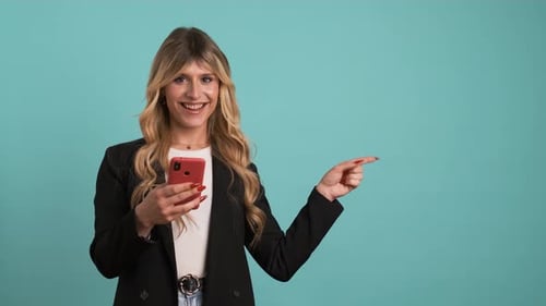 Smiling Woman Holds Phone Points to the Right