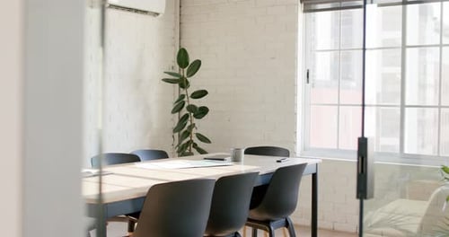 Empty modern office with meeting room with multiple projects on table