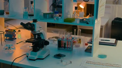 Microscope and Scientific Glassware in a Laboratory Setting