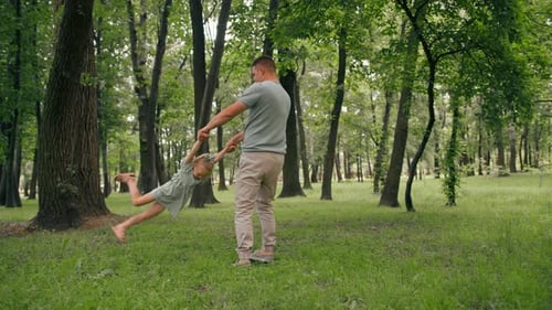Dad plays with a child in the park throws his daughter in the sky Happy family Father's Day Family