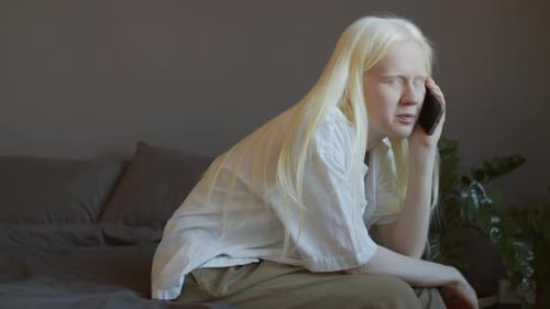 Young Adult Talking on Cell Phone Indoors