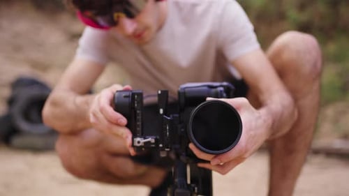 Young Adult Setting Up Camera Equipment