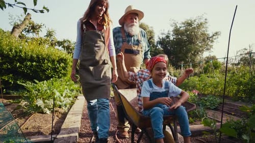 Family Gardening Together in the Countryside on Sunny Day