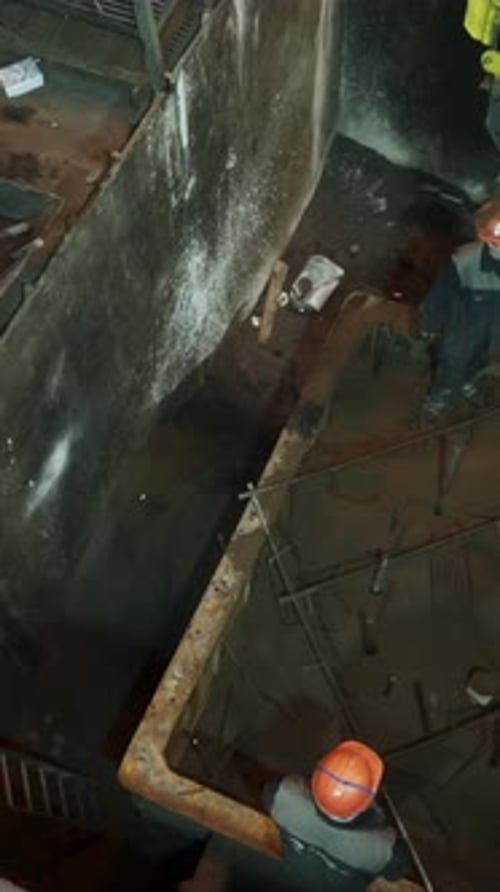 Industrial Workers Pouring Mixture Into a Large Container Stock Clip