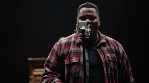 Passionate Singer Performing in a Dark Studio