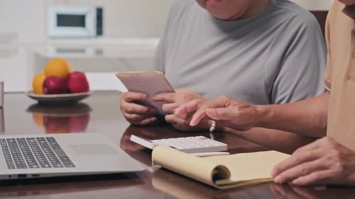 Senior Couple Planning Finances Together with Technology