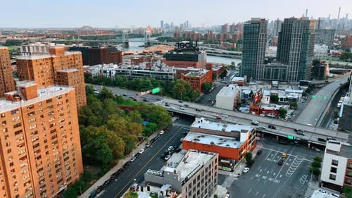 Flight above the buildings tops and busy roads. New York bridges over Hudson at backdrop.